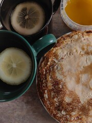 tea with lemon and pancakes