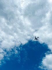 Passenger airplane flying in the sky clouds of the background. Commercial jet flying over clouds. Travel by air transport