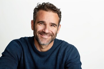 Obraz premium A man with a blue sweater and a smile on his face. He looks happy and content. Concept of warmth and happiness