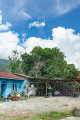 Colorful Rural House Surrounded by Nature Under Bright Blue Sky