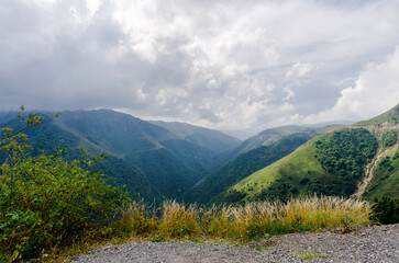 high mountains with green trees and clouds