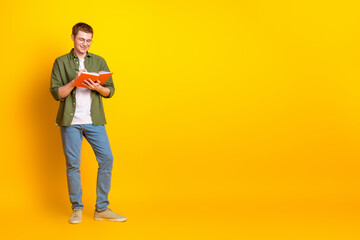 Photo of nice attractive man wear stylish khaki clothes hand hold book empty space isolated on vibrant yellow color background