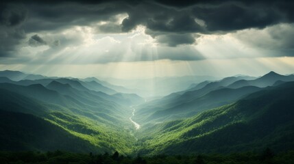 Obraz premium the morning sun shines through the clouds on the mountains of the valley and the forest in the fog.