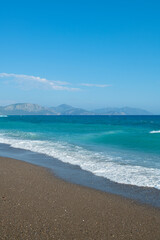 Pebble beaches. Beaches in Muğla. View from the beach to the sea. Magnificent beach, sea and blue cloudy sky.