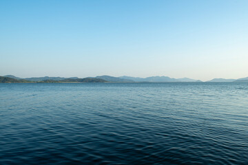 Pebble beaches. Beaches in Muğla. View from the beach to the sea. Magnificent beach, sea and blue cloudy sky.