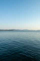 Pebble beaches. Beaches in Muğla. View from the beach to the sea. Magnificent beach, sea and blue cloudy sky.