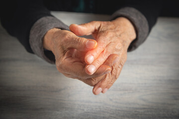 Fototapeta premium Caucasian elderly woman suffering from finger pain.