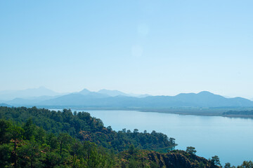 Bay views from green forests. View from the forest to the sea. Magnificent views from the forest to the sea. Magnificent bays of Muğla.