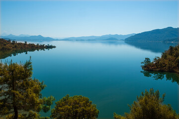 Bay views from green forests. View from the forest to the sea. Magnificent views from the forest to the sea. Magnificent bays of Muğla.