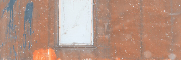 Texture of rusty metal wall with a boarded up window. Old uneven iron surface with stains of paint. Wide panoramic background for design.