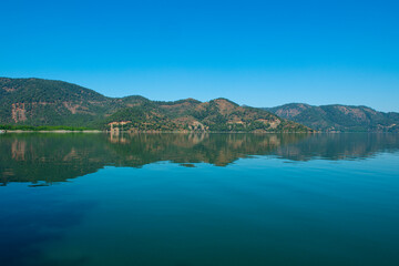 reflection of the forest in the lake.Bay views from green forests. View from the forest to the sea. Magnificent views from the forest to the sea. Magnificent bays of Muğla.