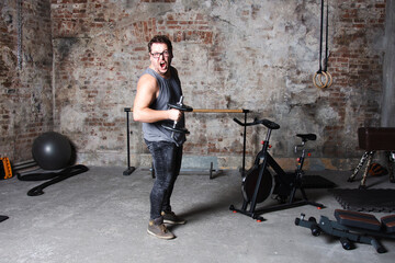 Lazy fat man doing fitness in the gym.