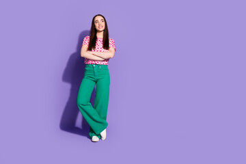 Full size photo of pretty young woman look empty space wear checkered t-shirt isolated on purple color background