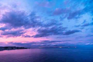 Dawn breaking over the cliffs of Bonifacio and Mediterranean sea on the south coast of Corsica with...