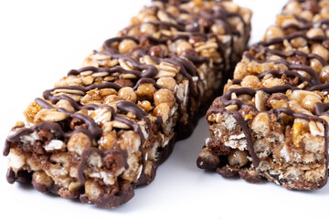 Healthy Muesli bars with nuts and black chocolate isolated on white background. Close up