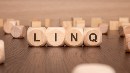 four wooden cubes with the text 'LING' on a brown background