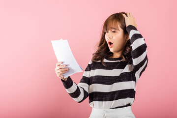 Portrait of beautiful Asian young woman sad tired strain holding paper calculating bills on hand, female person problem she hold worried over bill, studio shot isolated on pink background © sorapop
