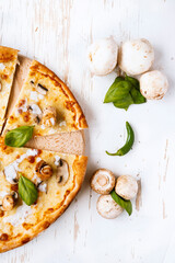 Tasty fresh baked pizza with champignons and chicken fillet