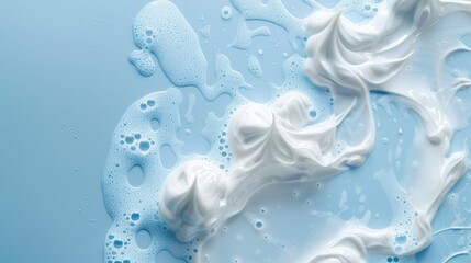 White face cleansing mousse sample on blue backdrop with empty space Close up of soap shower gel and shampoo foamy texture