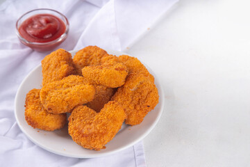 Golden chicken nuggets with ketchup sauce