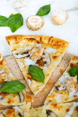 Tasty fresh baked pizza with champignons and chicken fillet