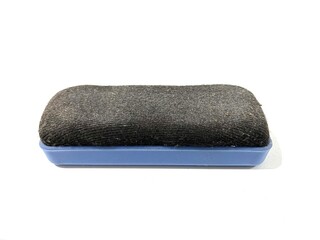 Dirty whiteboard marker eraser with blue handle isolated on white background