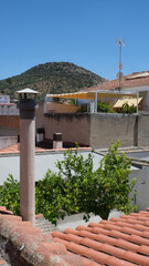 Cityscape with fireplace. Rooftops in rural Mediterranean population.