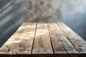 Empty rustic wood table surface with a sunlit grunge wall backdrop