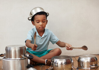Home, child and noise of pots for drum, rhythm and coordination for motor skills with metal beat....