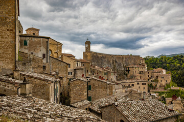 A glimpse of the ancient medieval village of Sorano, on a melancholy and rainy spring day. In the province of Grosseto, Tuscany, Italy. The old houses built in stone and tuff bricks.