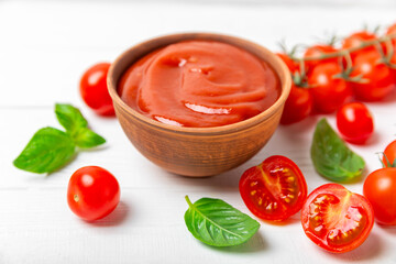Fresh cherry tomatoes and fresh green basil on a textured background. Tomato sauce. Vegan. Ingredients for salad. Organic food. Place for text. Copy space.