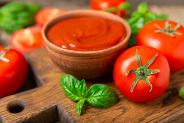 Fresh cherry tomatoes and fresh green basil on a textured background. Tomato sauce. Vegan. Ingredients for salad. Organic food. Place for text. Copy space.