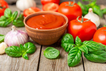 Fresh cherry tomatoes and fresh green basil on a textured background. Tomato sauce. Vegan. Ingredients for salad. Organic food. Place for text. Copy space.