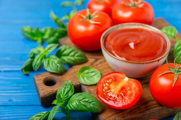 Fresh cherry tomatoes and fresh green basil on a textured background. Tomato sauce. Vegan. Ingredients for salad. Organic food. Place for text. Copy space.