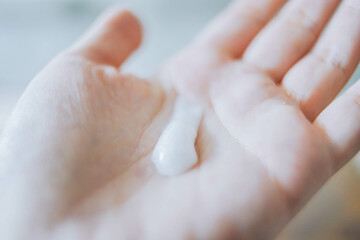 Woman applying natural cream, Woman moisturizing her hand with facial cleanser, Spa and Manicure concept.