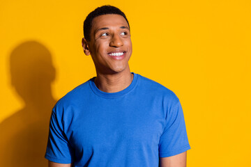 Fototapeta premium Photo portrait of handsome young guy look empty space dressed stylish blue garment isolated on yellow color background