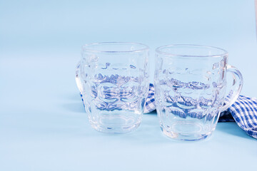 Oktoberfest background. Beer mug and Bavarian symbolic fabric