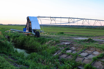 Field with mobile Irrigation system for water supply. Automatic field watering system.