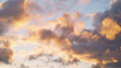 Quick moving soft fluffy clouds glow pink and red against blue sky at sunset, stunning natural background on a windy day - Powered by Adobe