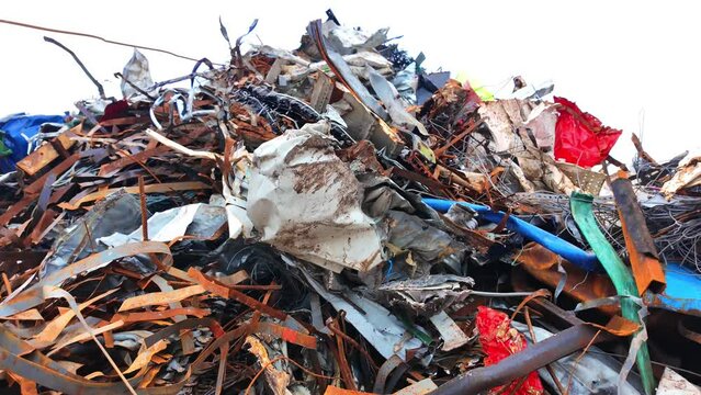 Close-up of a metal scrap pile in a recycling yard with rusted and twisted metal pieces. Ideal for recycling themes.