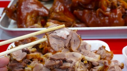 Succulent pork legs, simmered in a special broth, are presented cut into portions.