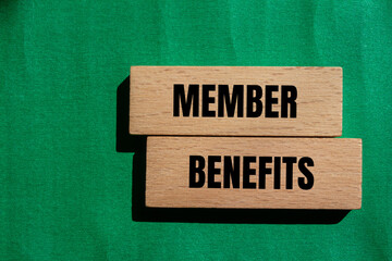 Member benefits message written on wooden blocks with green background. Conceptual member benefits symbol. Copy space.