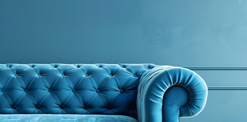 Obraz premium Photo of A blue velvet sofa on light blue background, with copy space for text or design. Web banner mockup.