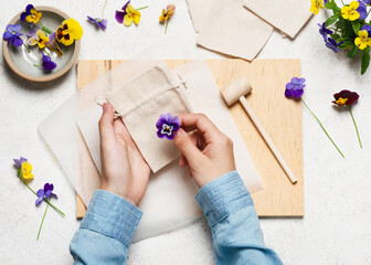 Step 1. Arrange a fabric bag on a hard surface and place the flowers on it. Hammered flower prints...