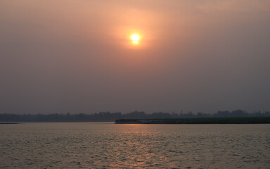 Naklejka premium sunrise over the river Brahmaputra in Bangladesh 