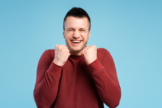 Closeup portrait of excited man, rejoicing after winning lottery, holding his fists in victory gesture