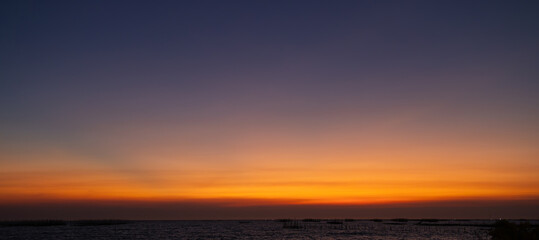 The sky is a beautiful orange color with a few clouds