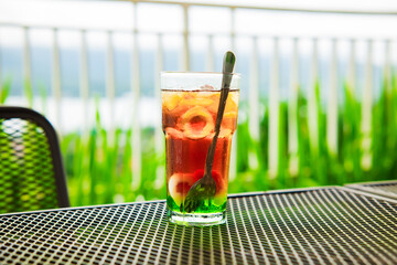 A glass of fresh drink on a table outdoors