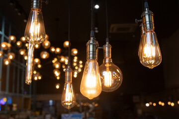 A bunch of light bulbs hanging from the ceiling