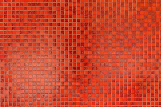 A red tile wall with a red background